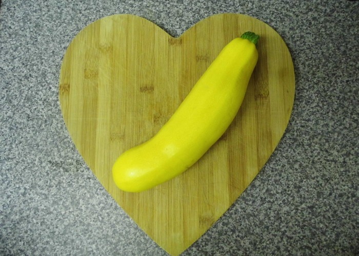 a yellow courgette on a chopping board
